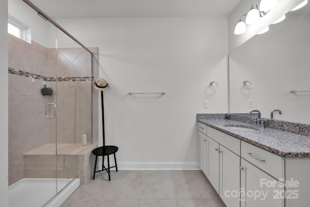 bathroom featuring a shower with door, vanity, and tile patterned flooring