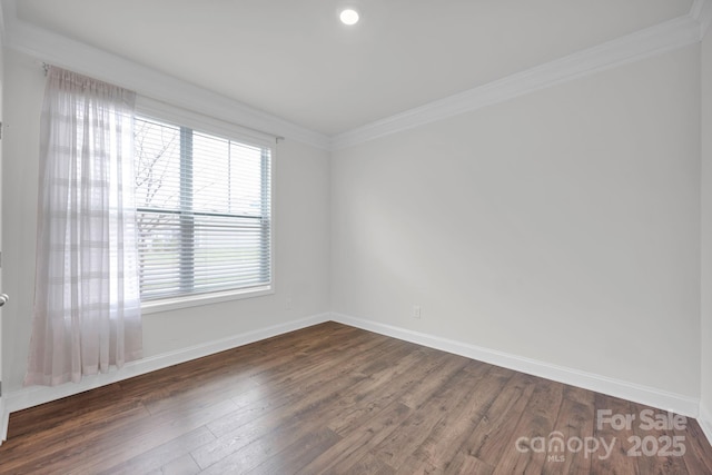 spare room with dark hardwood / wood-style floors and ornamental molding