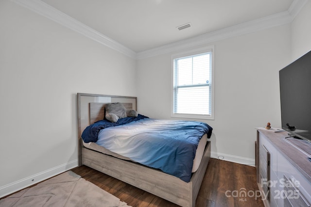 bedroom with crown molding and dark wood-type flooring