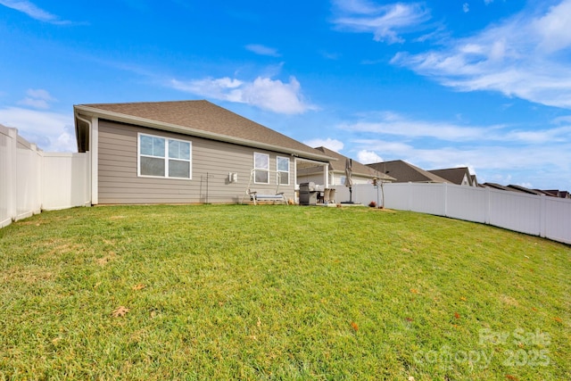 rear view of property with a lawn