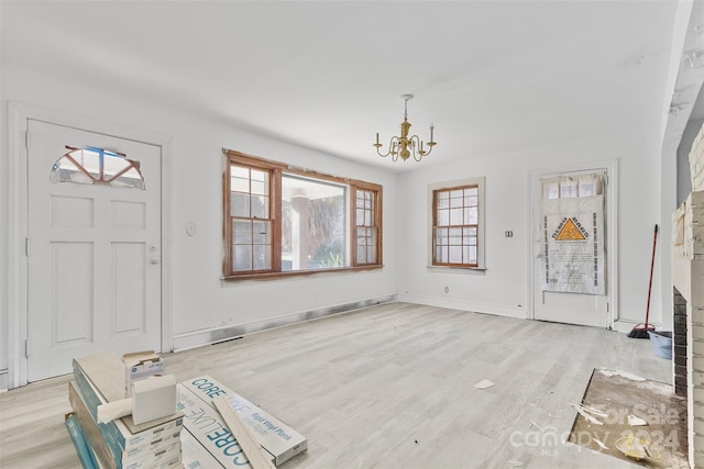 entrance foyer featuring light wood-type flooring and a notable chandelier