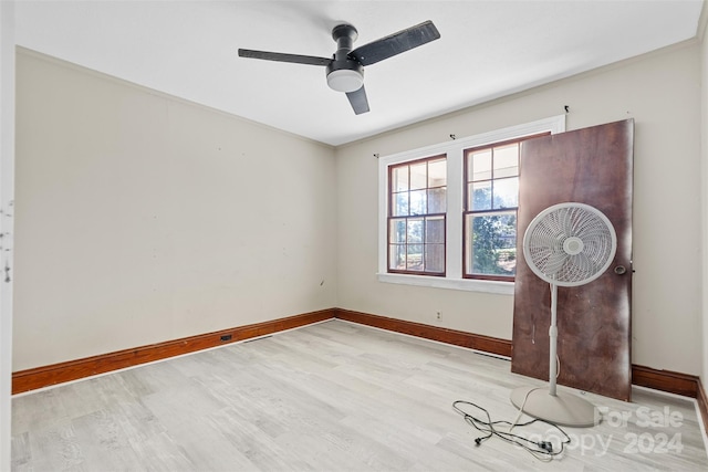 empty room featuring ceiling fan and light hardwood / wood-style flooring