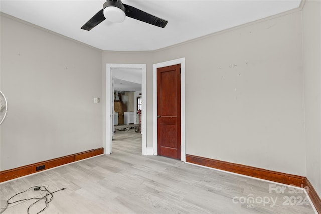 spare room with ceiling fan, ornamental molding, and light hardwood / wood-style flooring