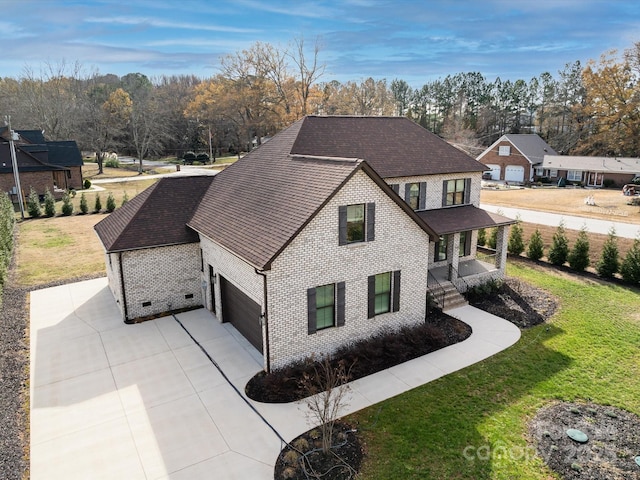 view of front facade featuring a garage and a front lawn