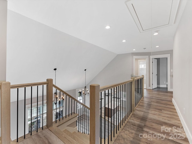 hall with hardwood / wood-style floors and vaulted ceiling