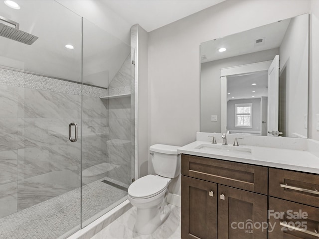 bathroom featuring toilet, an enclosed shower, and vanity