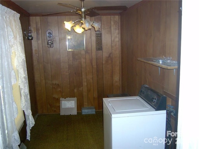 laundry room with wooden walls, ceiling fan, washer / clothes dryer, and dark colored carpet