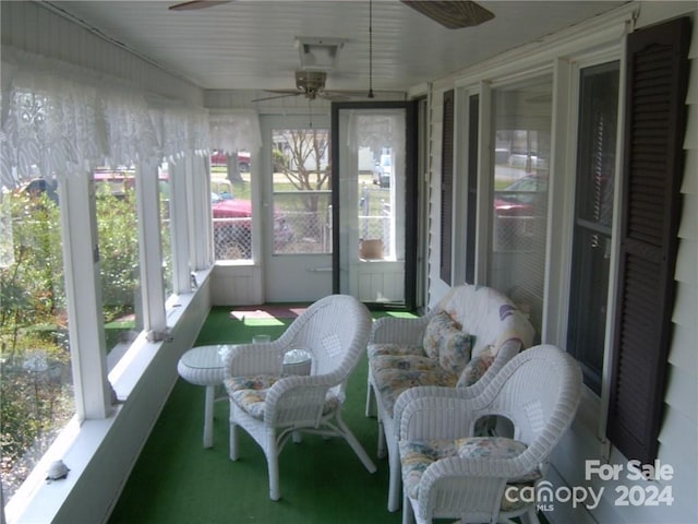 sunroom / solarium with plenty of natural light and ceiling fan