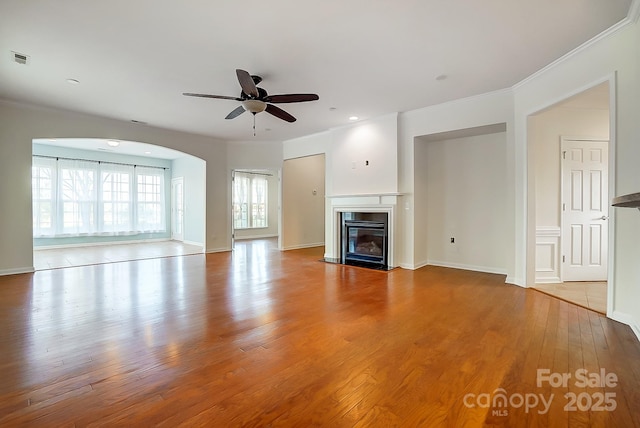 unfurnished living room featuring light wood-type flooring, ceiling fan, and ornamental molding