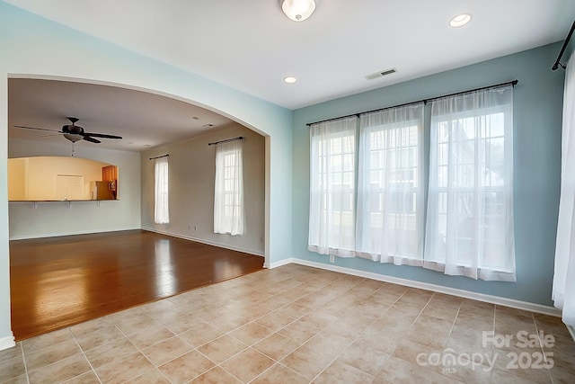 tiled empty room with ceiling fan