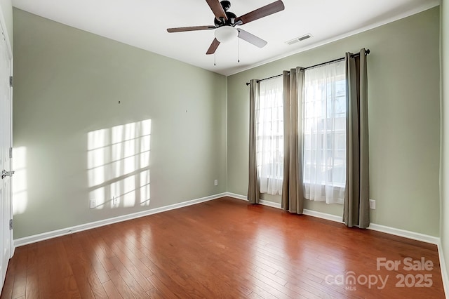 empty room with hardwood / wood-style flooring and ceiling fan