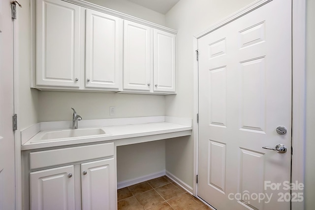 clothes washing area with light tile patterned floors and sink