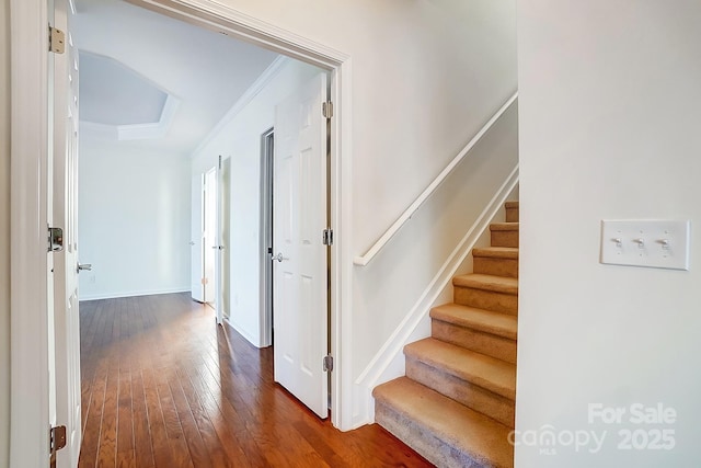 interior space featuring crown molding and dark hardwood / wood-style floors