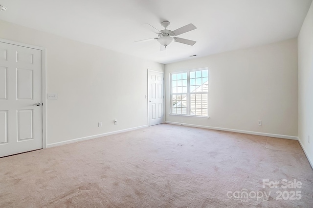 unfurnished room with ceiling fan and light carpet