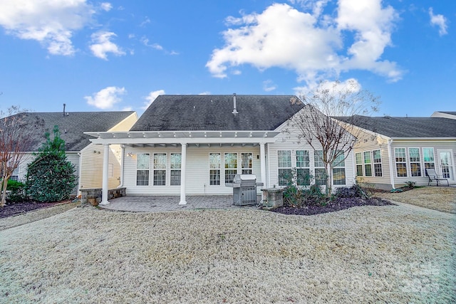 back of property featuring a pergola and a patio