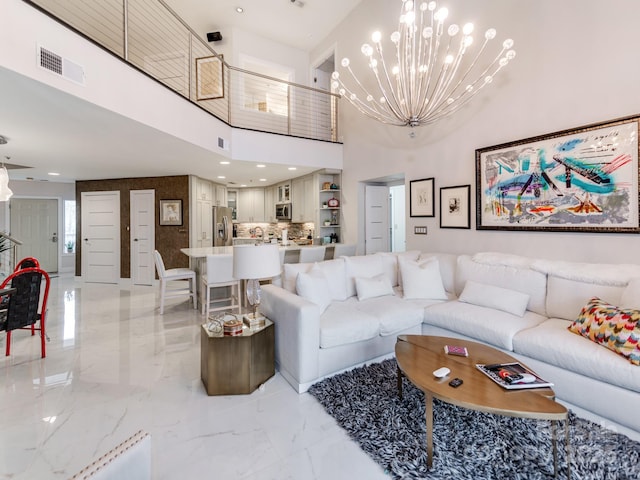 living room featuring a high ceiling and a chandelier