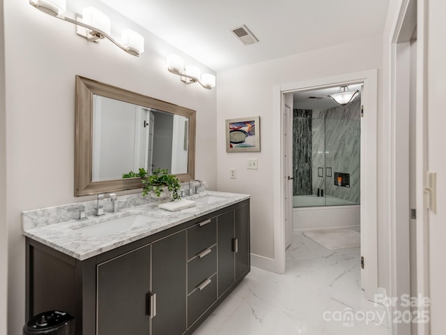 bathroom with vanity and combined bath / shower with glass door