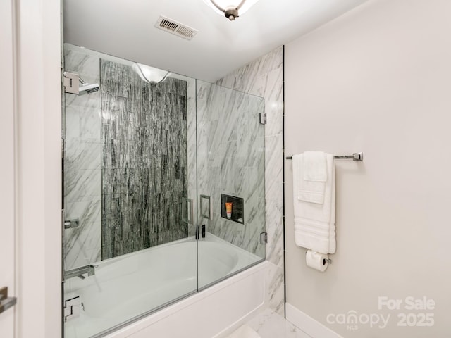 bathroom featuring bath / shower combo with glass door