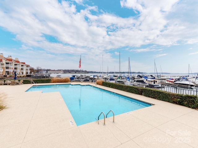 view of pool with a water view