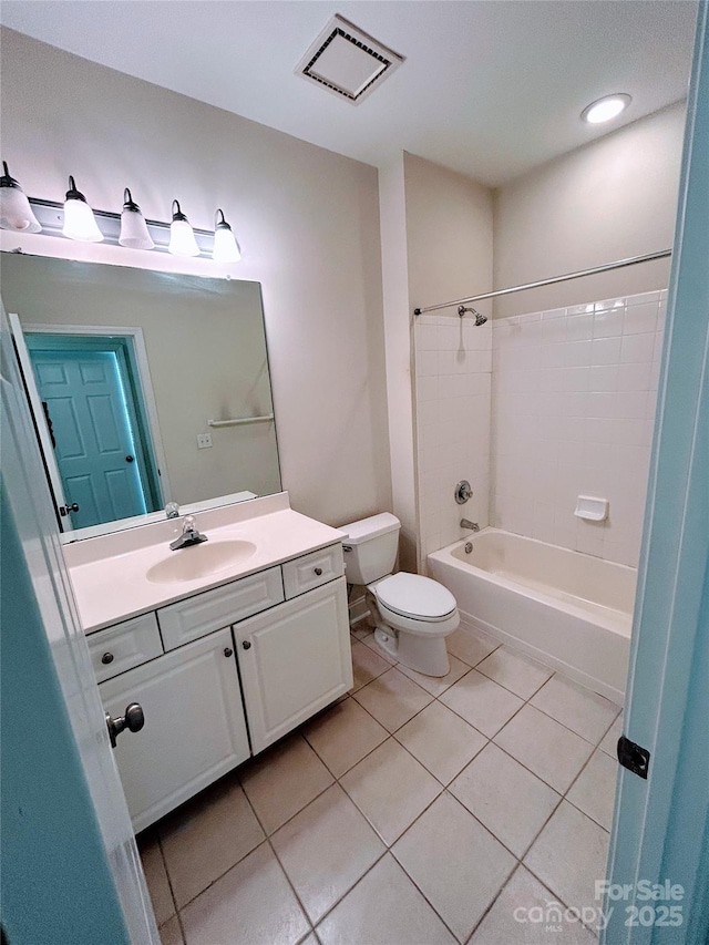 full bathroom featuring vanity, toilet, tiled shower / bath combo, and tile patterned flooring