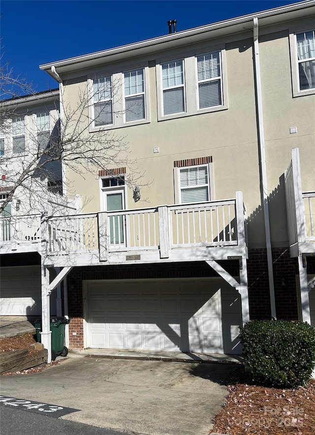 exterior space featuring a garage and a balcony