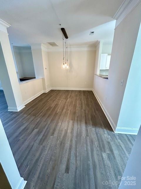 interior space featuring crown molding and dark wood-type flooring