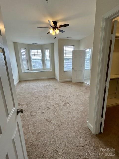 unfurnished room featuring light carpet and ceiling fan