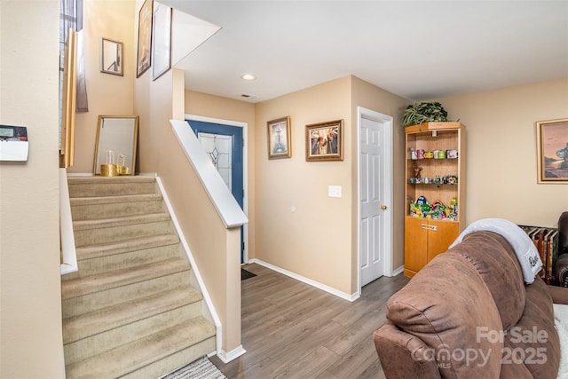 stairs featuring wood-type flooring