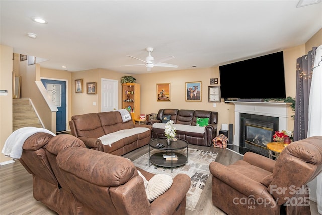 living room featuring ceiling fan and light hardwood / wood-style floors