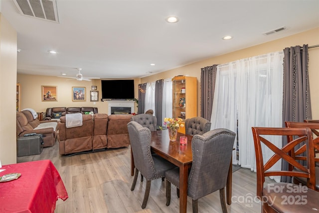 dining room with ceiling fan and light hardwood / wood-style floors