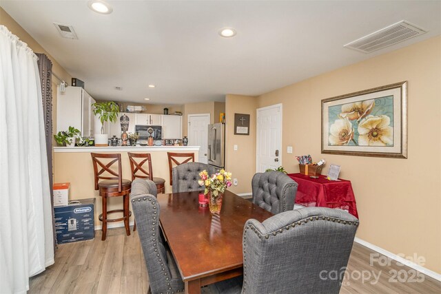 dining area with light hardwood / wood-style flooring