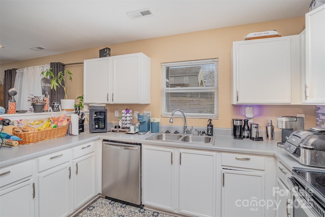 kitchen with appliances with stainless steel finishes, white cabinetry, and sink