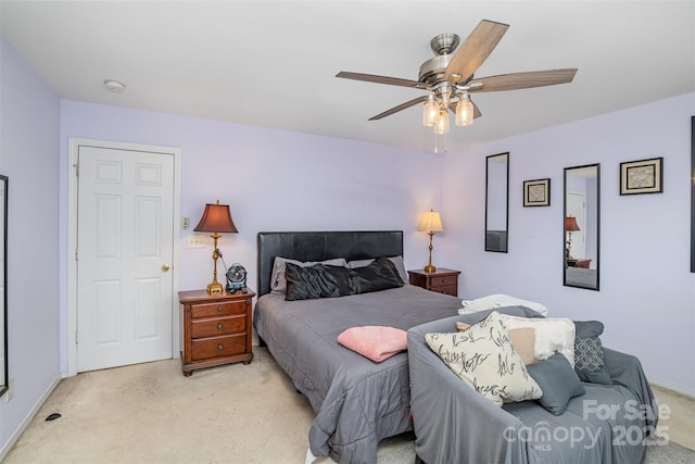 bedroom with ceiling fan and light carpet