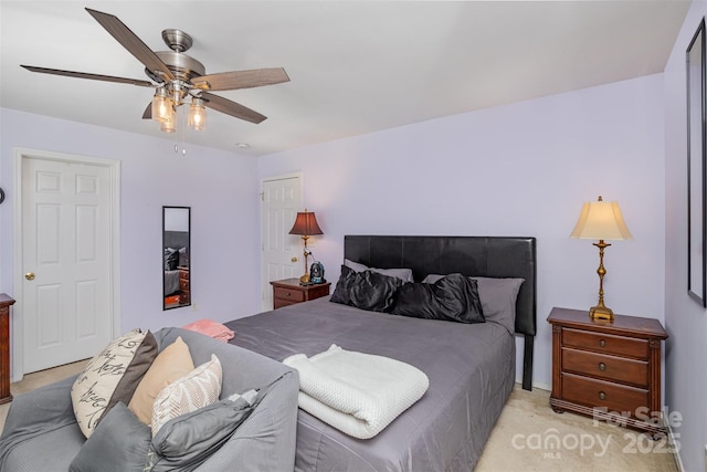 bedroom featuring ceiling fan and light carpet