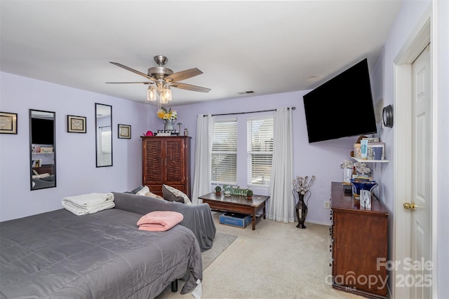 bedroom with ceiling fan and light carpet