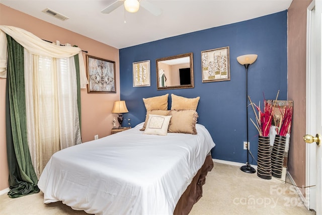 bedroom with ceiling fan and light colored carpet