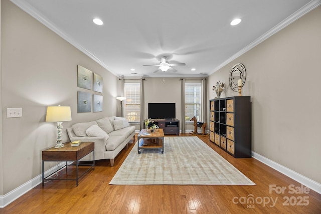 living room with ceiling fan, ornamental molding, and wood-type flooring