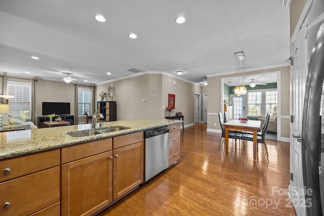 kitchen with light hardwood / wood-style floors, crown molding, light stone counters, sink, and stainless steel dishwasher