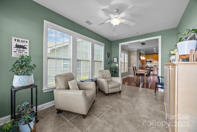 living area with ceiling fan