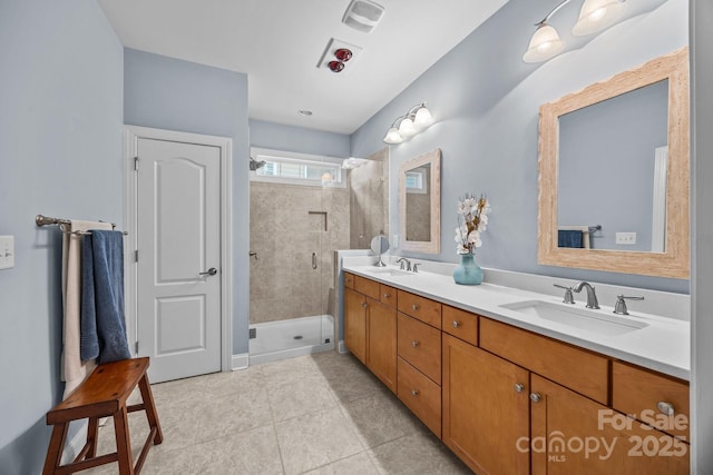 bathroom featuring a shower with door, tile patterned floors, and vanity