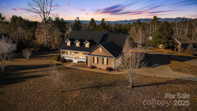 view of front of house with a porch and a mountain view