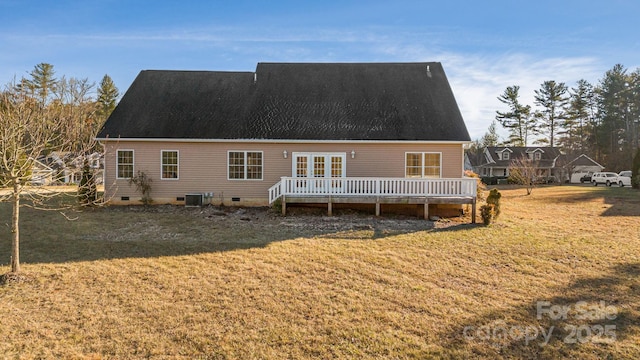 back of property featuring central AC unit, a wooden deck, and a lawn