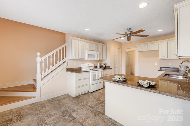 kitchen with white appliances, kitchen peninsula, ceiling fan, a textured ceiling, and sink