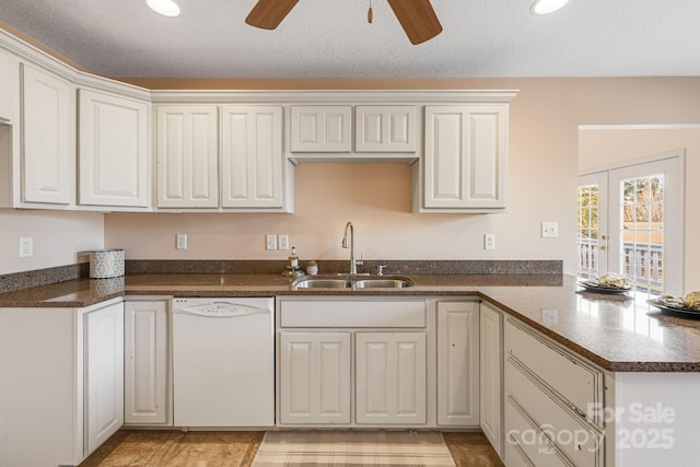 kitchen with sink, white cabinets, and dishwasher