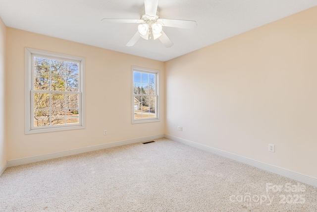 spare room with ceiling fan and carpet