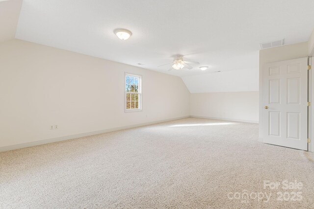 bonus room with carpet floors, ceiling fan, and vaulted ceiling