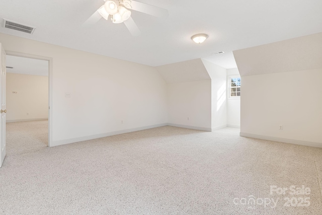 additional living space featuring lofted ceiling, ceiling fan, and light colored carpet