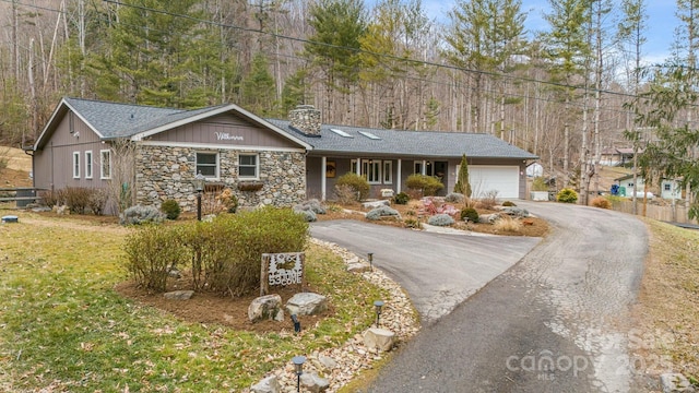 ranch-style house featuring a garage and a front yard