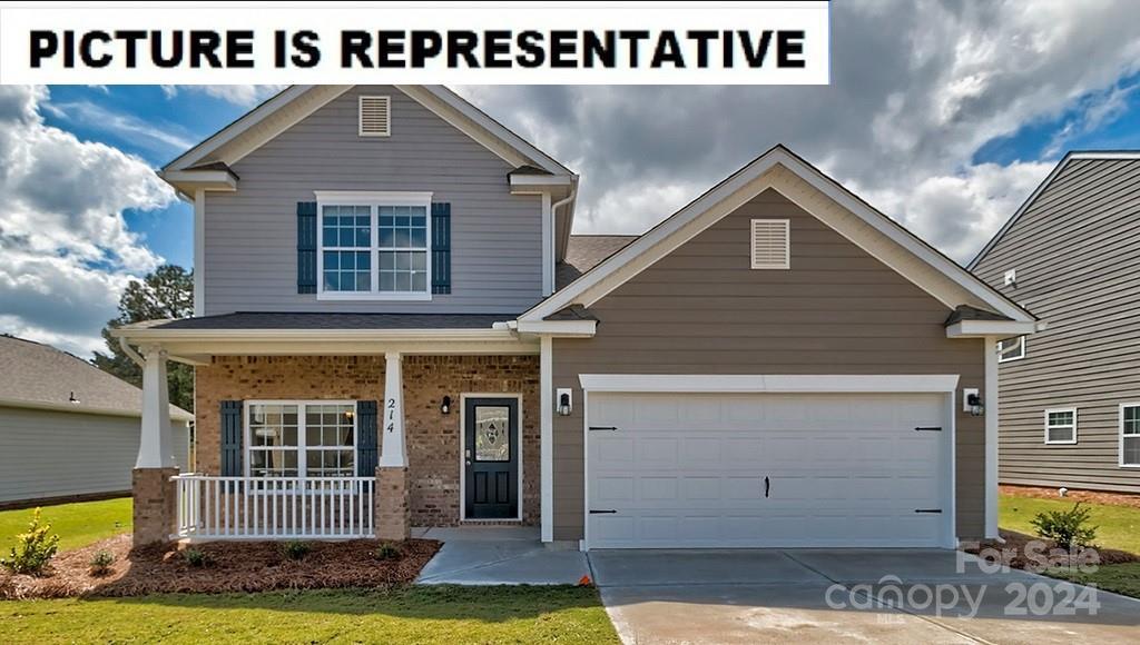 craftsman-style home with a garage, covered porch, and a front lawn