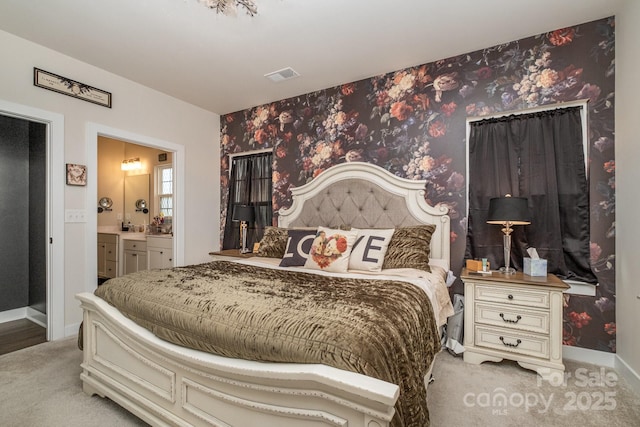 carpeted bedroom featuring ensuite bathroom